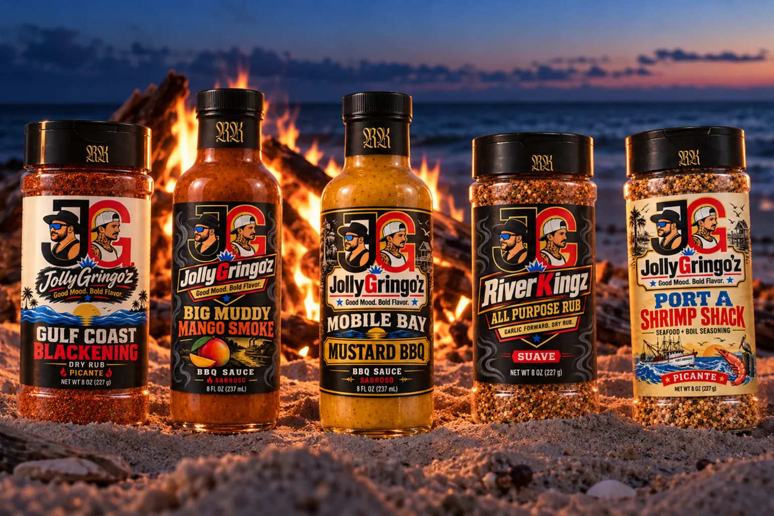 JollyGringo'z bottles lined up on the sand in front of a beach bonfire at dusk